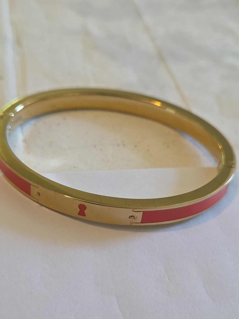 Fossil Gold-Tone Bangle with Coral Pink Enamel Keyhole Detail